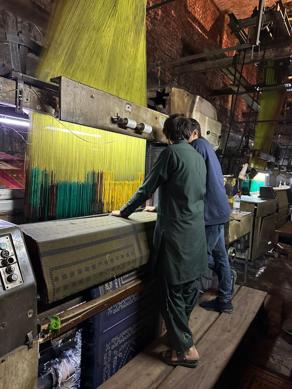 AMTI craftsmen at the loom machine